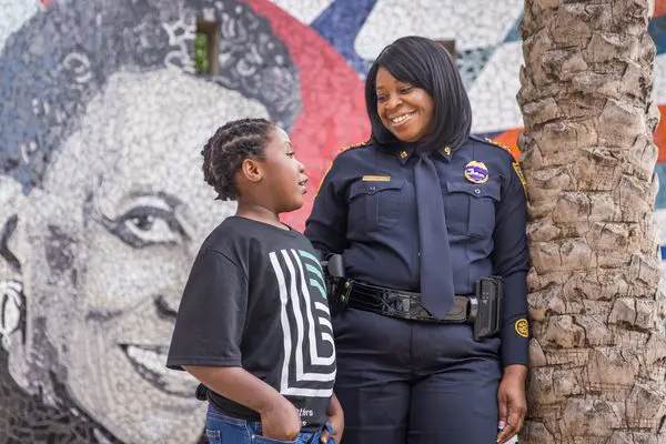 A woman and child in uniform standing next to each other.