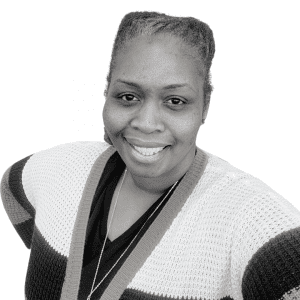 A black and white photo of a woman smiling.